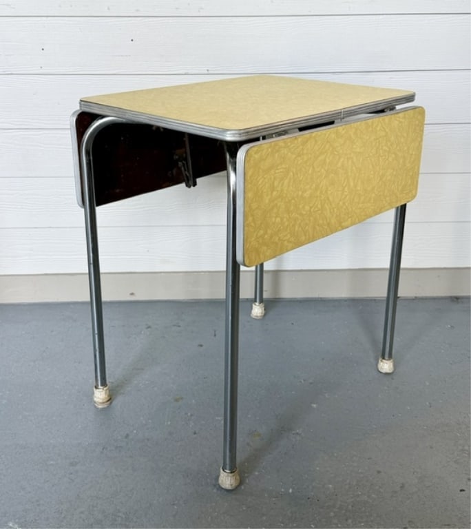 MCM 1950's Formica Drop Leaf Table: MCM 1950's Drop leaf table. Table features vibrant patterned yellow laminate formica top supported by sleek chrome legs. In excellent condition for age with some pitting present on chrome and slight