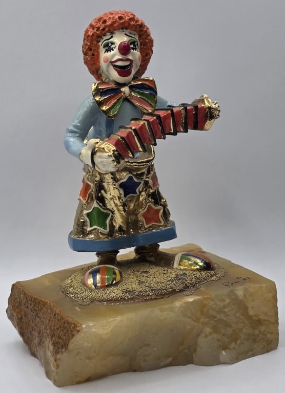 Vintage Signed Ron Lee "Accordion" Clown Figurine: Vintage 1981Ron Lee "Accordion / Squeeze Box" figurine. Hand painted metal and enameled sculpture features a classic clown in a light blue shirt and star patterned skirt playing a red accordion, with 