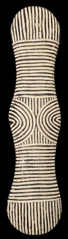 Vintage Hand Carved African "Dancing Shield": Vintage hand carved elongated African "Dancing Shield". Shield features bold black and white geometric patterns. Some minor cosmetic imperfections. Approximately 45.5"h x 10"w. Photos are considered p