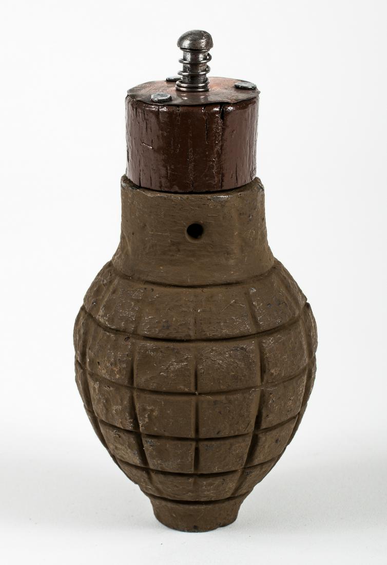 WWI FRENCH CITRON FOUG GRENADE W/ FUZE: Very rare early WWI French Citron Foug hand grenade model 1916 with the wooden percussion plug igniter. A defensive grenade, cast iron, shaped like a lemon, hence its nickname, with an outer grid patt