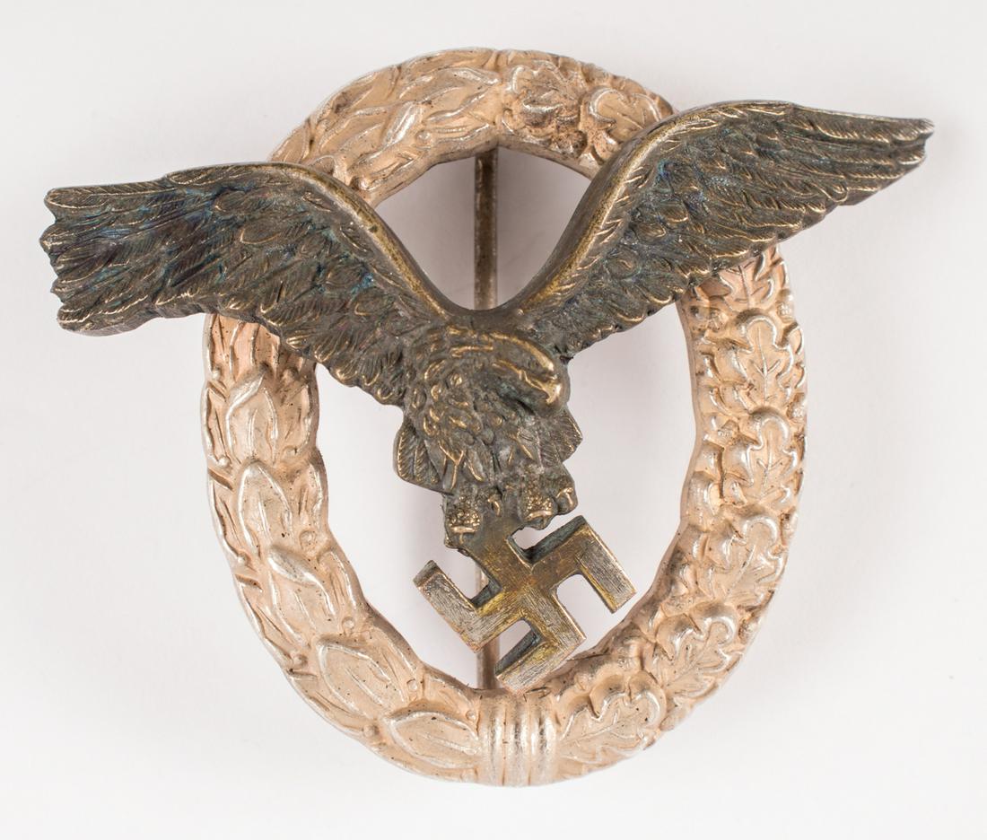 WWII GERMAN LUFTWAFFE PILOT'S BADGE DEUMER: WWII GERMAN LUFTWAFFE PILOT'S BADGE DEUMER Luftwaffe Pilot's badge features a swooping eagle clutching a mobile swastika in its talons. The eagle is superimposed on a wreath of half laurel and half oa