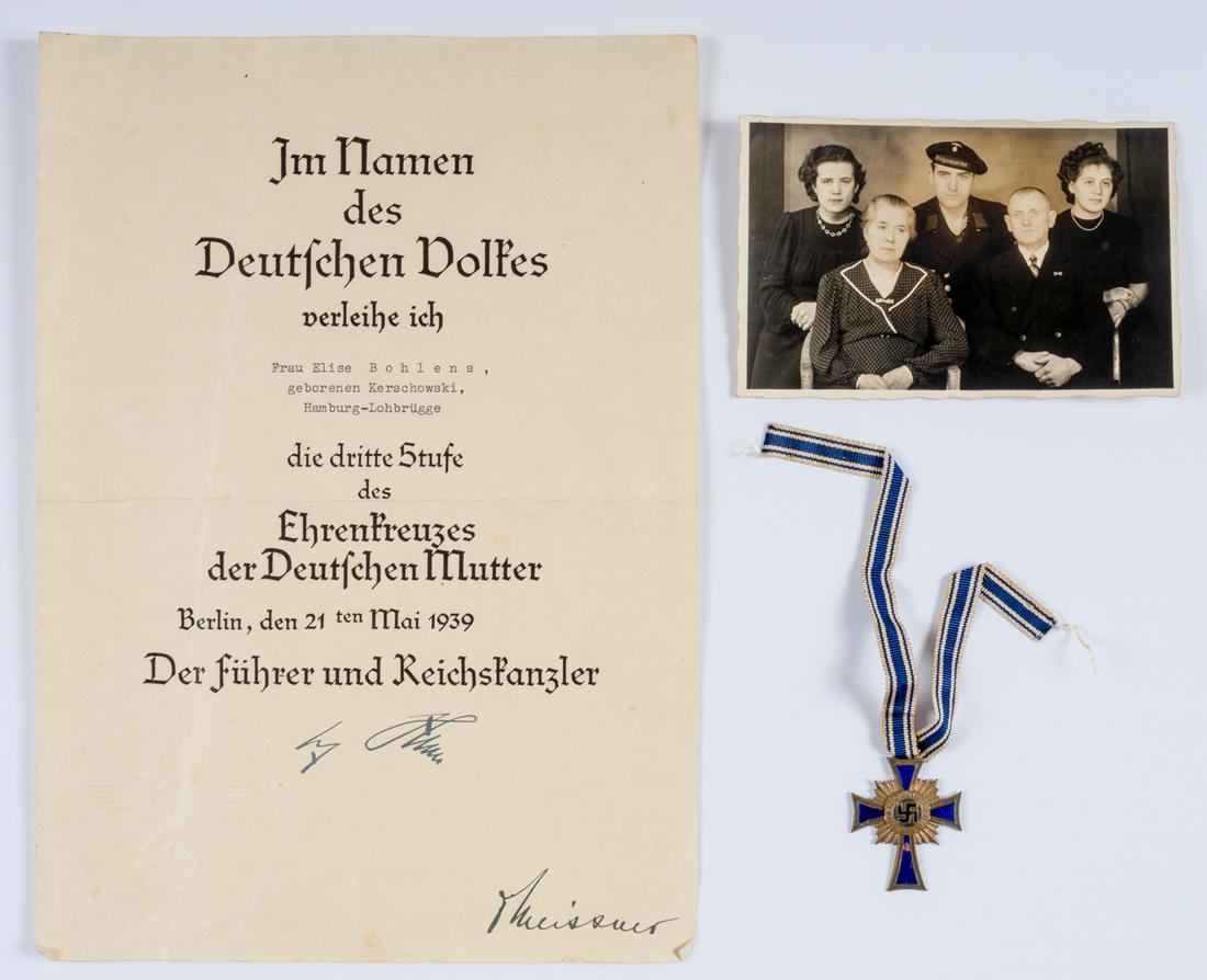 WWII MOTHER'S CROSS AND AWARD CERTIFICATE: WWII MOTHER'S CROSS AND AWARD CERTIFICATE Group of items honoring the German mother; includes an award document for a Mother's Cross 3rd class presented to Elise Bohlens of Hamburg, with facsimile sig