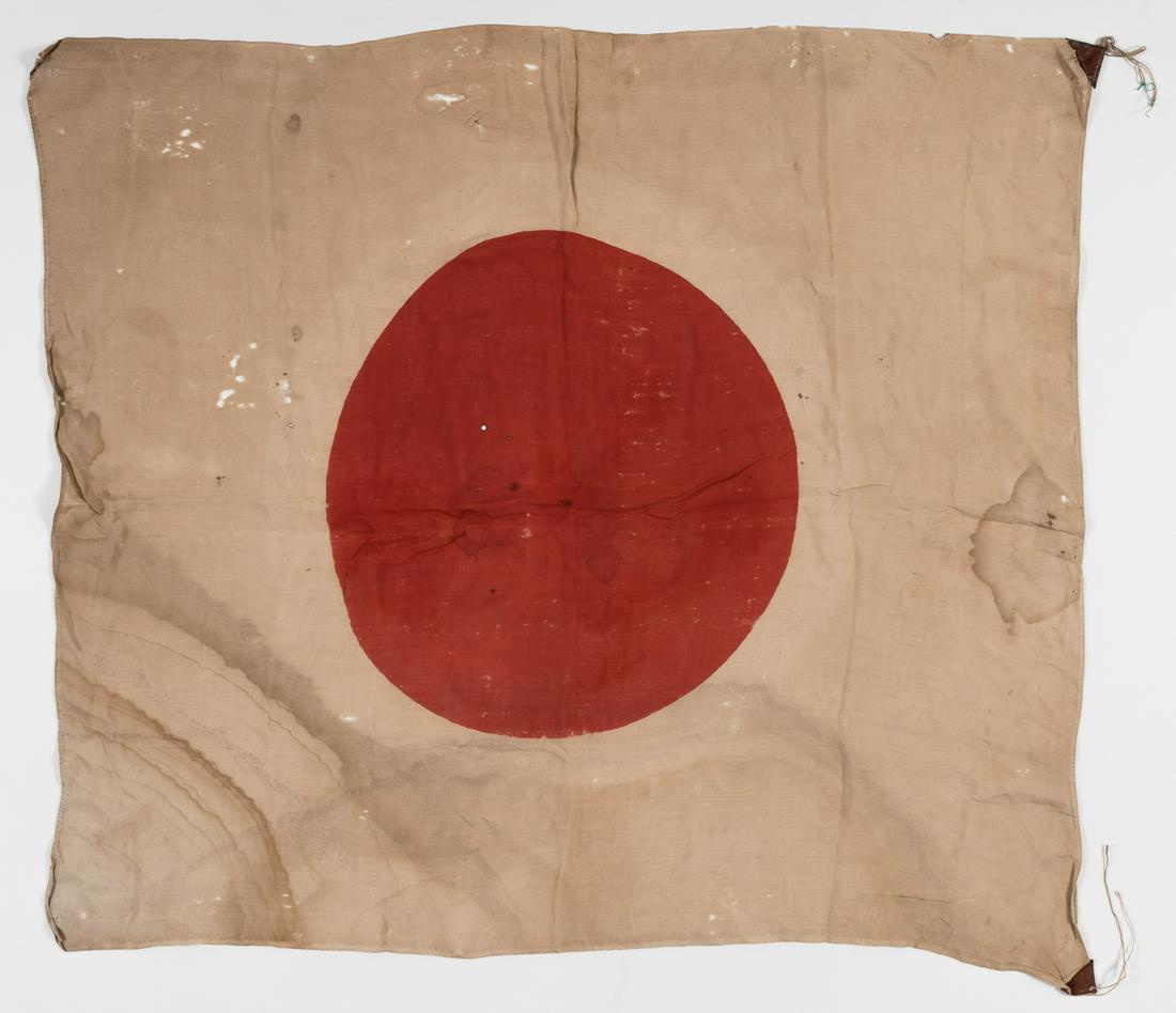 WWII JAPANESE NATIONAL FLAG: WWII JAPANESE NATIONAL FLAG Large Japanese national flag measuring 29' x 32'. Both leather corner tabs are intact, with some staining to flag (blood?) and wear.