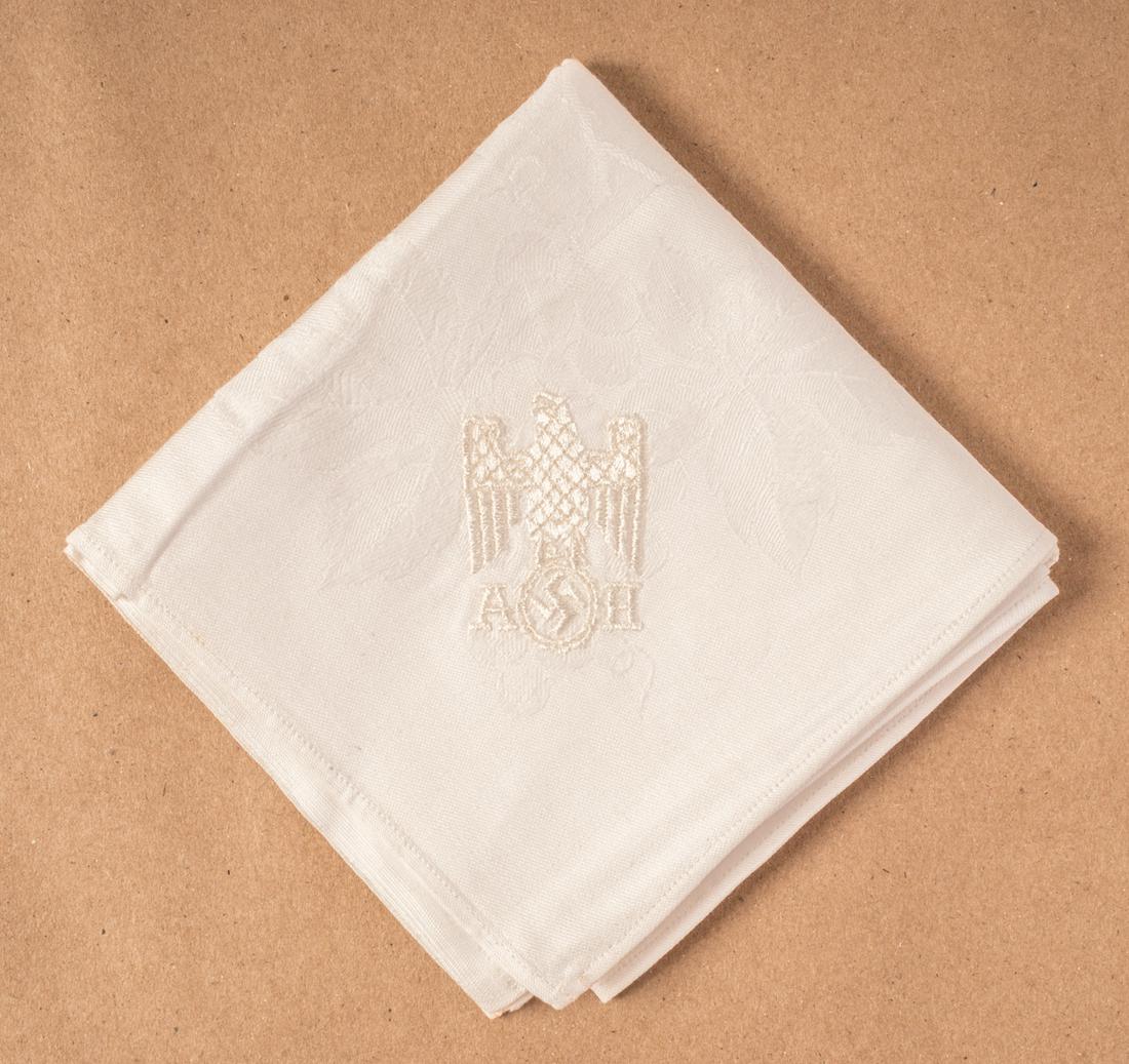 ADOLF HITLER DINNER NAPKIN: ADOLF HITLER DINNER NAPKIN Very fine white linen napkin embroidered with Adolf Hitler's initials and the German eagle and swastika in one corner. Dimensions circa 19 x 19 inches square. Very good.
