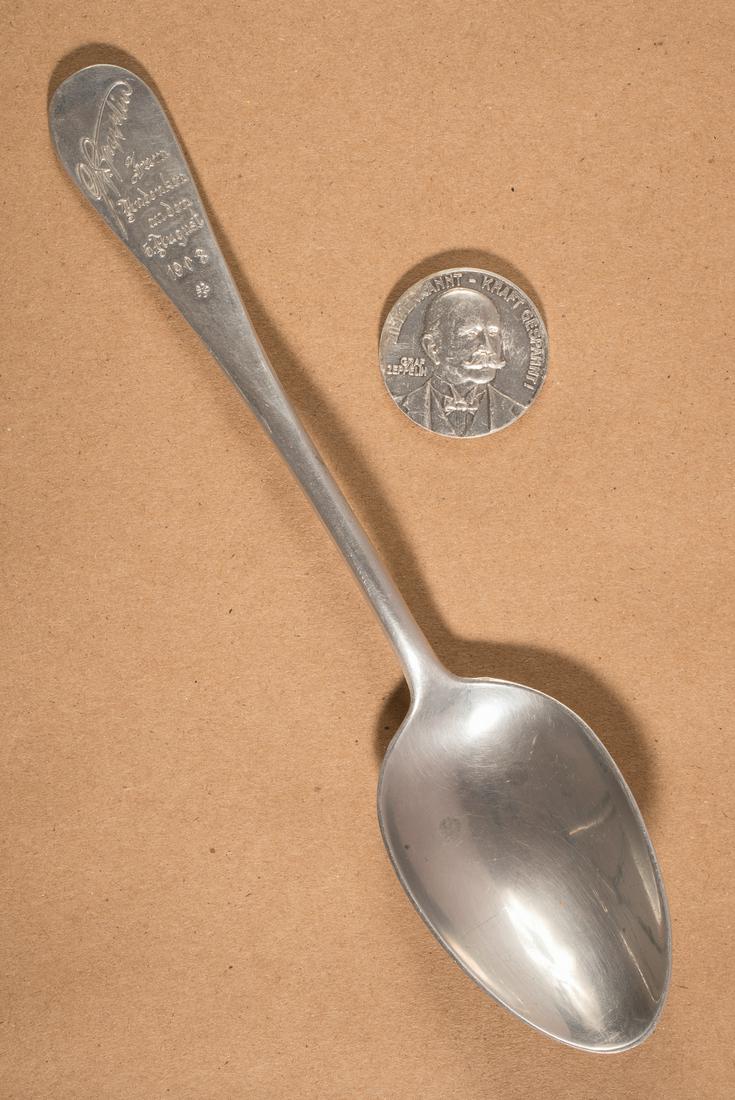 ZEPPELIN LZ 4 CRASH SOUVENIRS (2): ZEPPELIN LZ 4 CRASH SOUVENIRS (2) Lot of two Zeppelin LZ 4 souvenirs cast from remaining aluminium of the crashed airship, includes: a spoon, 8.25 inches long, the handle engraved with the facsimile s