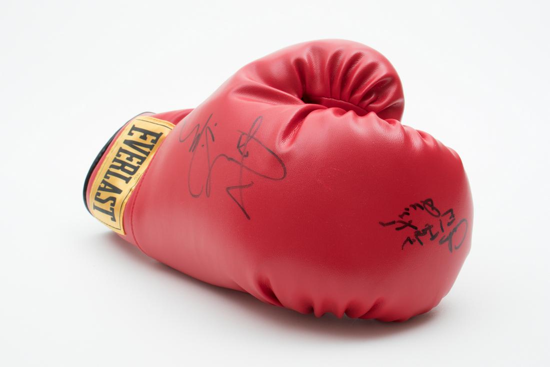 MIGUEL COTTO & CARLOS QUINTANA SIGNED EVERLAST BOXING: MIGUEL COTTO & CARLOS QUINTANA SIGNED EVERLAST BOXING GLOVE Red Everlast boxing glove signed in black ink by Miguel Cotto and Carlos Quintana. Miguel Cotto (b. 1980) American-born Puerto Rican former