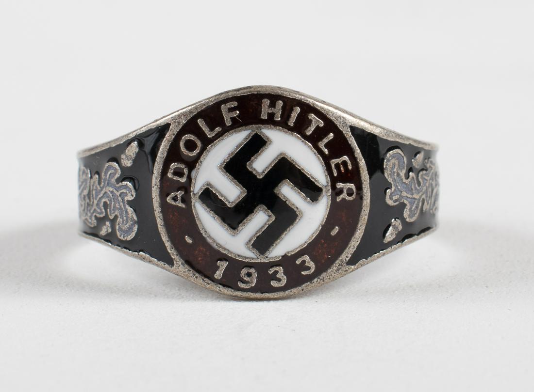 GERMAN 1933 NSDAP HITLER RING: German 1933 NSDAP party ring, enameled in red, white, and black, featuring a swastika surrounded by the words 'Adolf Hitler 1933' flanked by oak leaves. Unauthenticated, sold as-is.