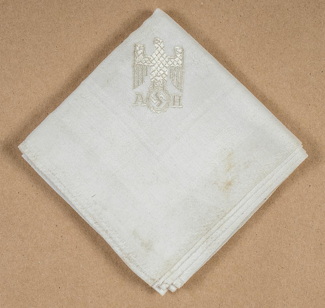 ADOLF HITLER NAPKIN: Very fine white linen napkin embroidered with Adolf Hitler's initials and the German eagle and swastika in one corner. Dimensions circa 20 x 20 inches square. Very good.