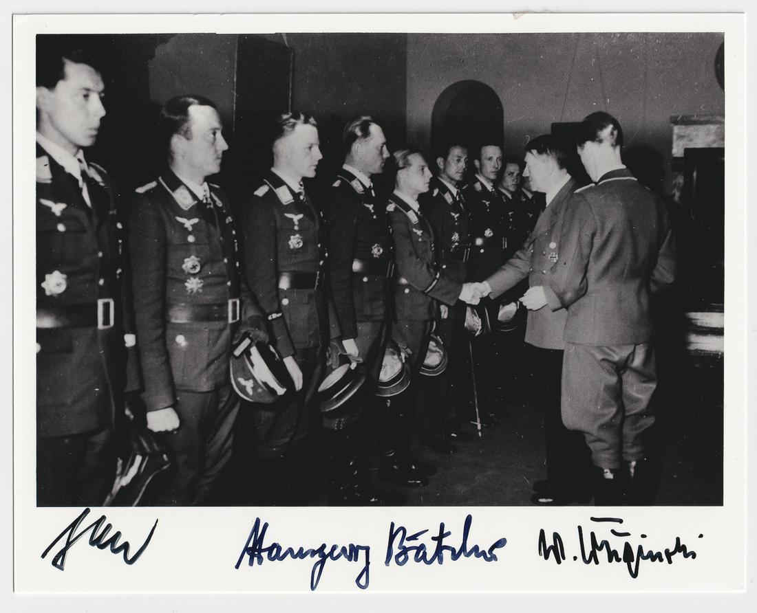 LUFTWAFFE ACES KRUPINSKI, BAETCHER & JABS: LUFTWAFFE ACES KRUPINSKI, BAETCHER & JABS Signed award ceremony photograph showing Luftwaffe aces WALTER KRUPINSKI, HANSGEORG BAETCHER, HANS-JOACHIM JABS meeting with Adolf Hitler. 5 x 6.25 inches bla