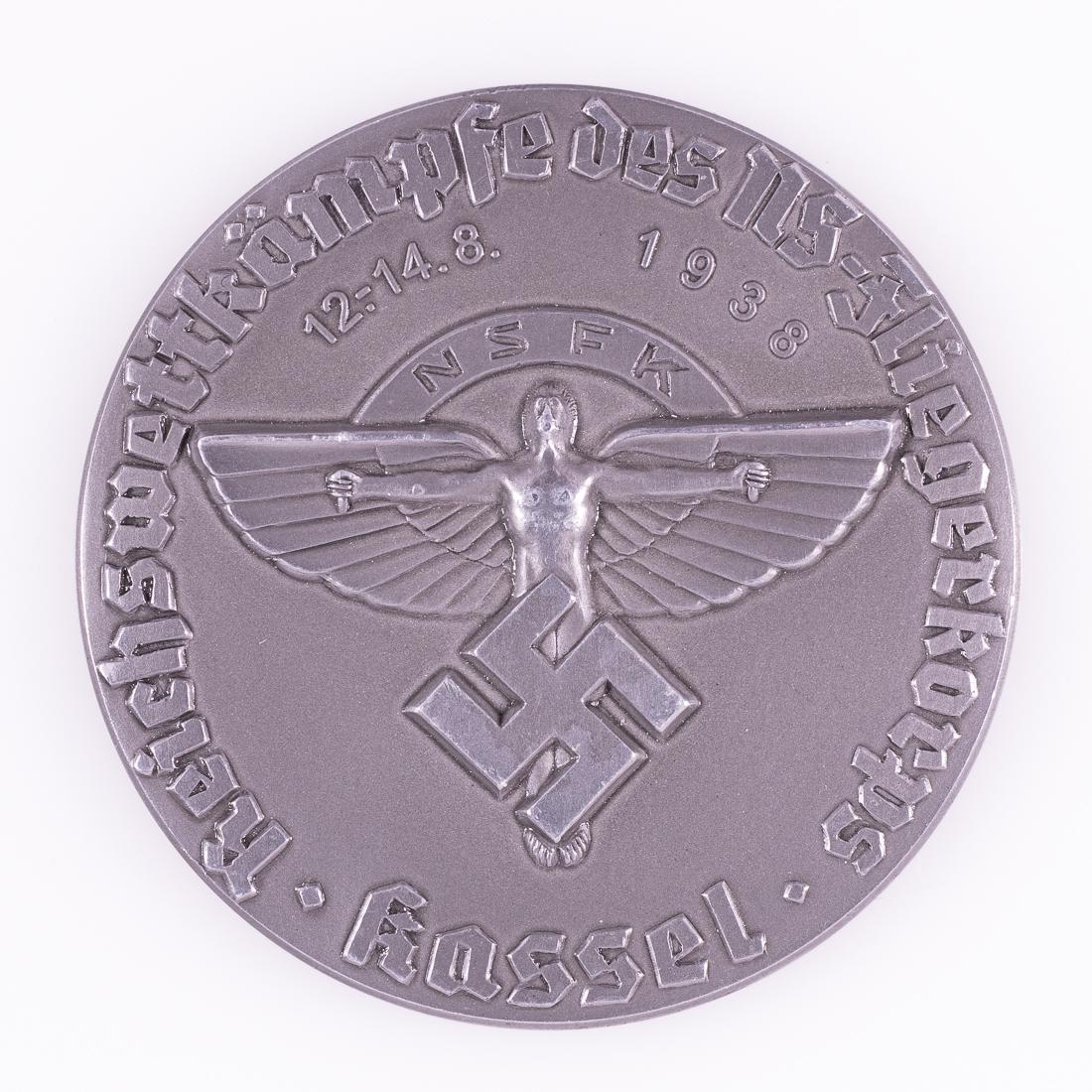 WWII NSFK FLIEGER KORPS MEDAL 1938: WWII NSFK FLIEGER KORPS MEDAL 1938 German NSFK (National Socialist Flyers Corps) table medal for the Reichs Competition of the NS-Flyers Corps in Kassel, August 12-14, 1938. Constructed of cast alumin