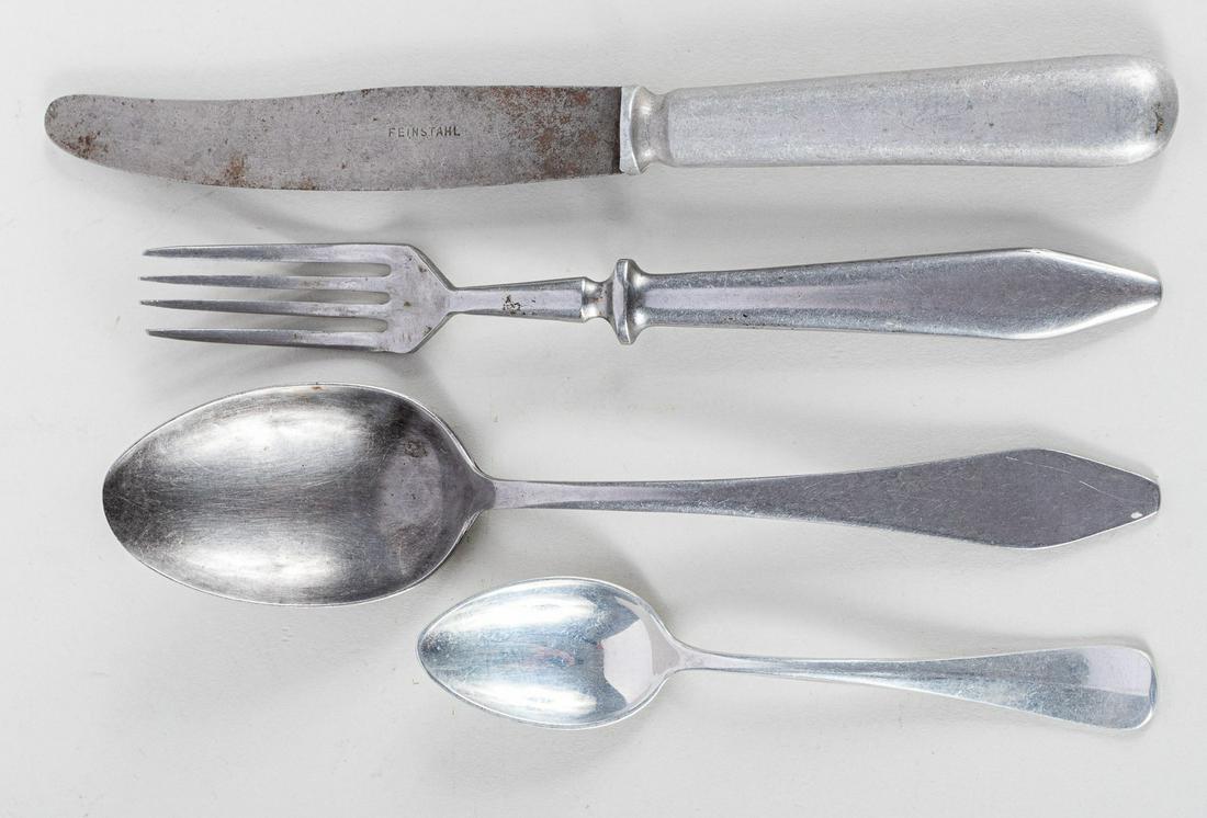 AUSCHWITZ HOSPITAL DINNER FORK & SPOON: Lot of four items. Firstly a pair of dinner fork and spoon, each 8 inches long, from a canteen serving the Auschwitz Municipal Medical Institutions in Poland and marked 'Stadtische Krankenanstalten Au
