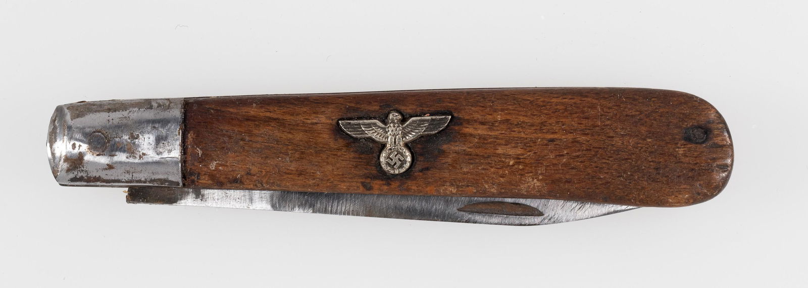 GERMAN SOLDIER'S POCKET KNIFE: Soldier's pocket knife with the Nazi eagle insignia, wooden handle, blade is marked 'Eickhorn Solingen.' Knife is undated, 7 inches fully opened.