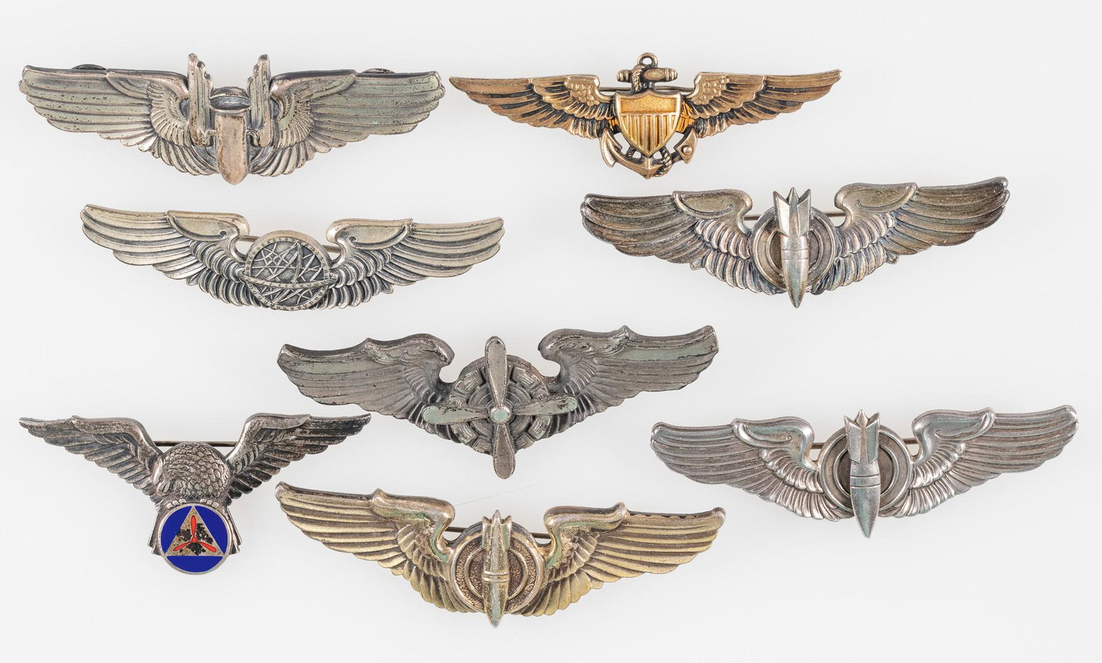 EIGHT WWII U.S. PILOT WING PINS (8): Group lot of eight WWII U.S. pilot wings. Includes Aerial Gunner wings; marked sterling; Flight Engineer wing; three U.S. Bombardier, marked sterling; Civil Air Patrol Pilot, marked sterling; Navigato
