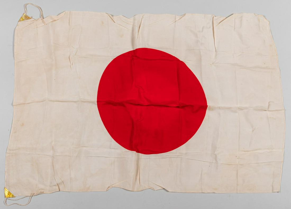 WWII JAPANESE NATIONAL FLAG: Large Japanese national flag measuring approx. 26' x 38'. Both corner tabs are intact, with some staining to flag and wear.