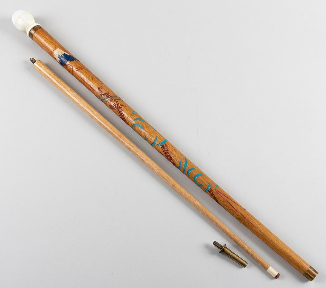 WWII WALKING STICK AND POOL CUE: A veteran's bring back from his service time in Japan, a Japanese style pool cue and cane, likely from WWII. Cane sheathe is hand carved and painted in Japanese style with a red dragon breathing fire