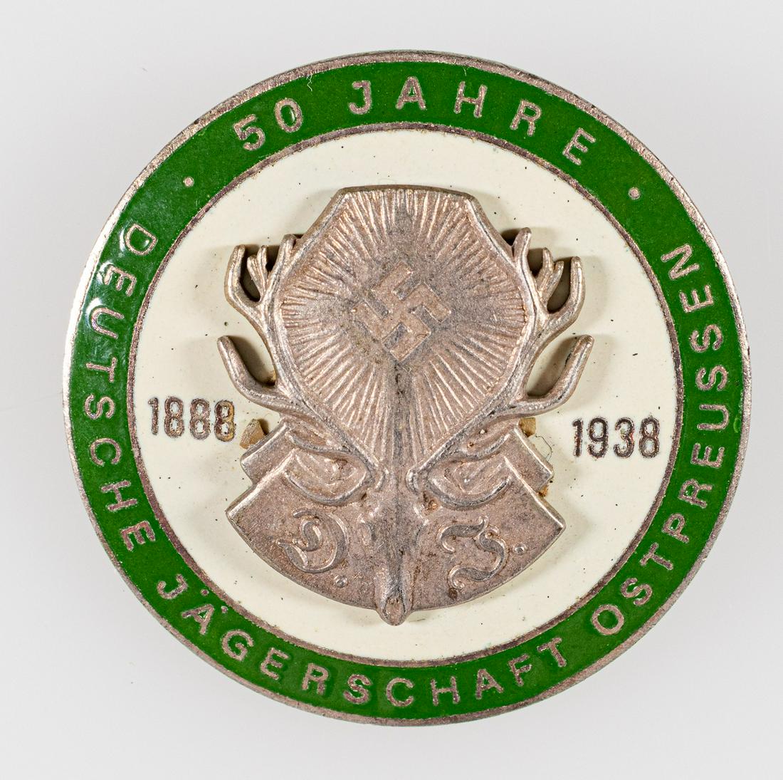 GERMAN HUNTING 50 YEAR BADGE: Badge commemorating the 50th Anniversary of the German Hunting Society. Green and white enameled pin which reads, '50 Years - 1888 1938 - German Hunters Association East Prussia'. The center shows a d