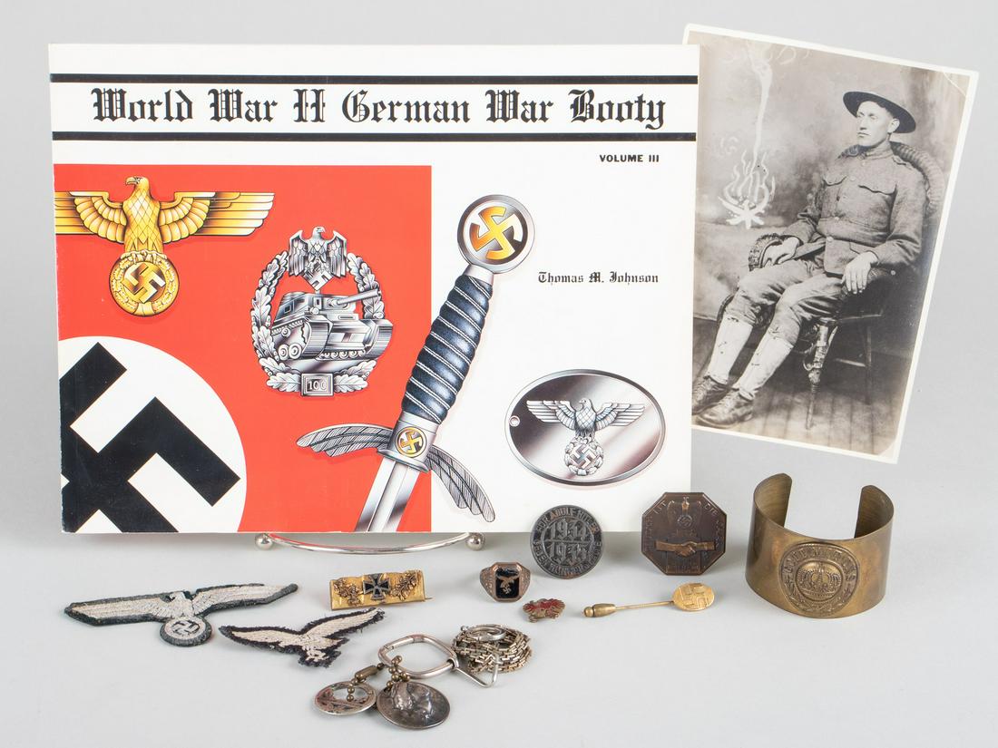 GERMAN NAZI PINS AND PARAPHERNALIA (12): Lot of assorted pins and badges of WWI and WWII, includes a Luftwaffe and Heer breast eagles, WWI trench art bracelet and a small sweetheart pin made from spent shells, a Luftwaffe ring, a key fob wit