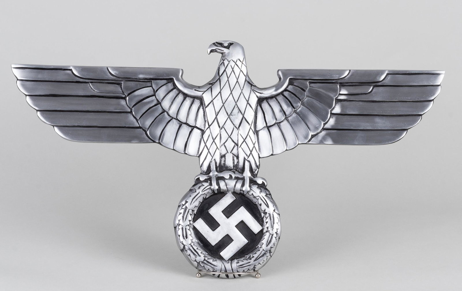 GERMAN RAILWAY EAGLE REPRODUCTION: German WWII railway eagle with a 27.5 wingspan by 15 inches tall. Blackened cast aluminum front, with four threaded mounting holes on the back. Reproduction.
