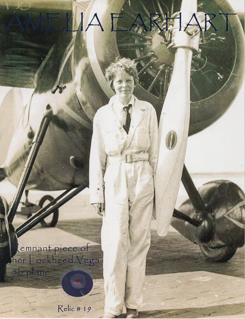 AMELIA EARHART PLANE FABRIC RELIC: Pane fabric relic from the Lockheed Vega 5B plane flown by Amelia Earhart attached to a photograph of Earhart and the plane. In the Vega 5B, she set the record for flying solo across the Atlantic and 