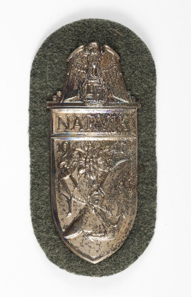 NARVIK SHIELD 1940 SILVER: NARVIK SHIELD 1940 SILVER Narvik silver sleeve shield with a large eagle and swastika dated '1940' green wool backing with paper on the reverse side.