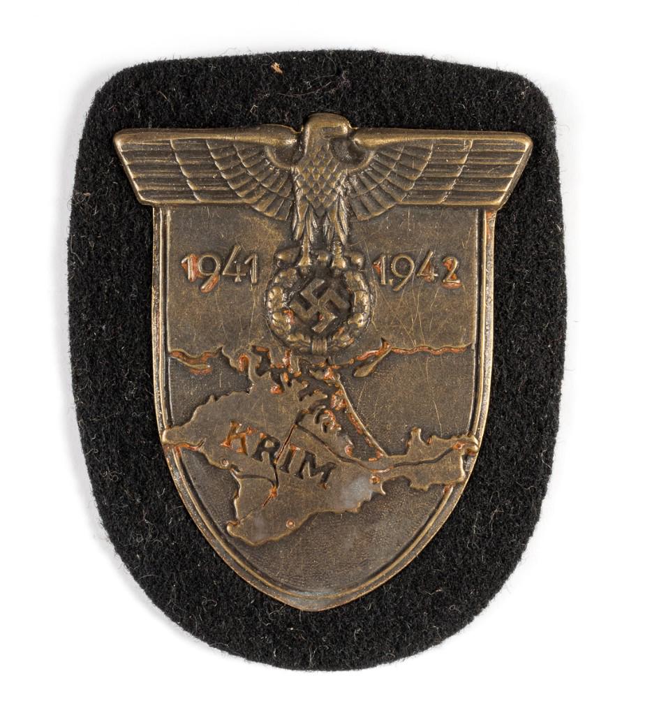 WWII GERMAN KRIM SHIELD PANZER: WWII GERMAN KRIM SHIELD PANZER German Crimean (Krim) campaign uniform sleeve shield, set on black wool with paper backing. Panzer issue.