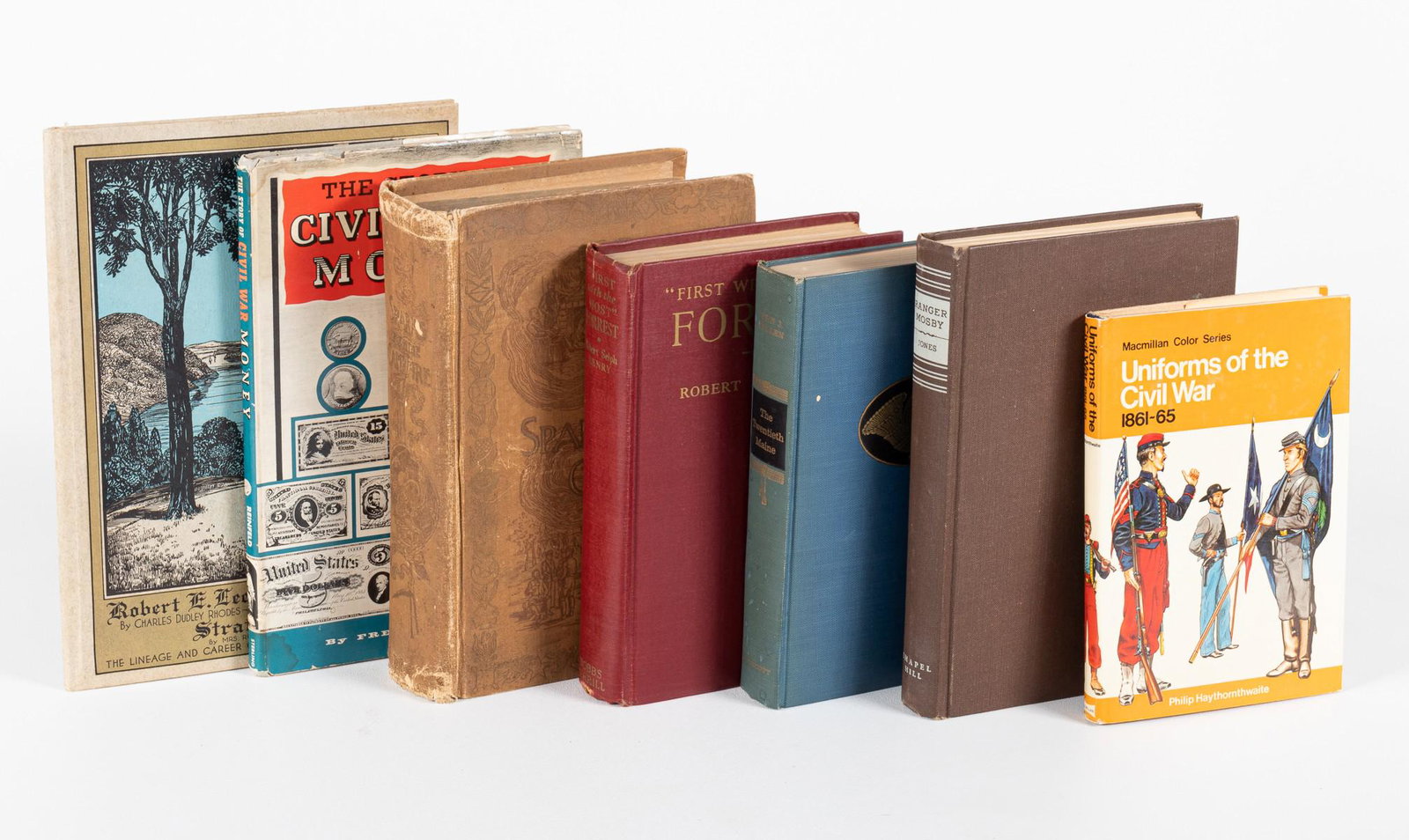 7 CIVIL WAR BOOKS: Seven books about the Civil War including a biography of Robert E. Lee, Uniforms of the Civil War reference book, Civil War money reference book, Ranger Mosby, The 20th Maine, First with the Most Forr