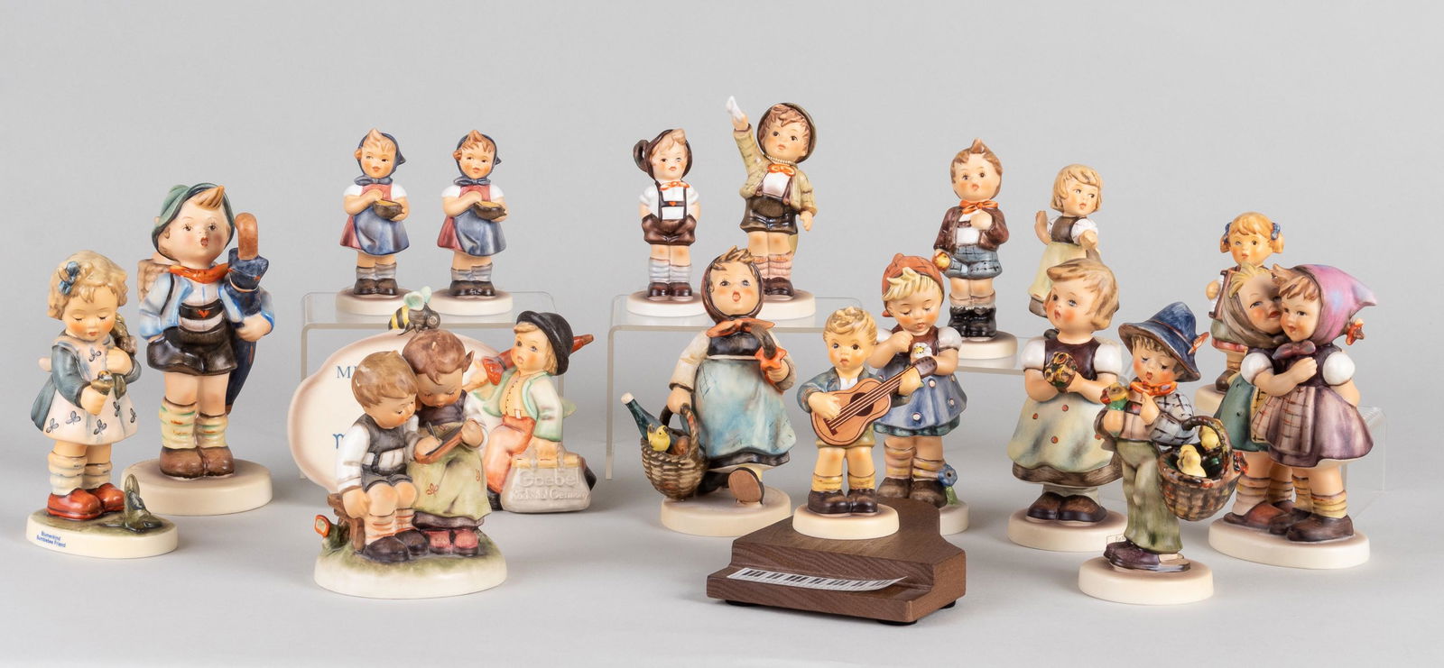 17 GOEBEL HUMMEL FIGURINES: Lot of seventeen Goebel Hummel figurines, including 'Keeps # 102', 'Bumblebee Friend #1775', 'Visiting an Invalid', and others.