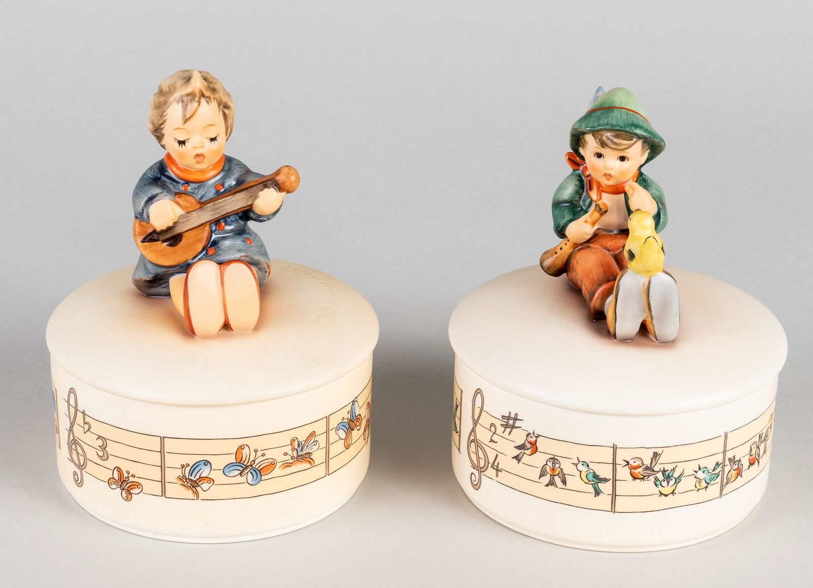 2 HUMMEL LIMITED EDITION MUSIC BOXES: Lot of two original M.I. Hummel music boxes: HUM IV/53 'Gesangsprobe' (singing lesson) playing the German childrens song 'The songs are ringing' and HUM IV/63 's stimmt net' (it's not right) playing t