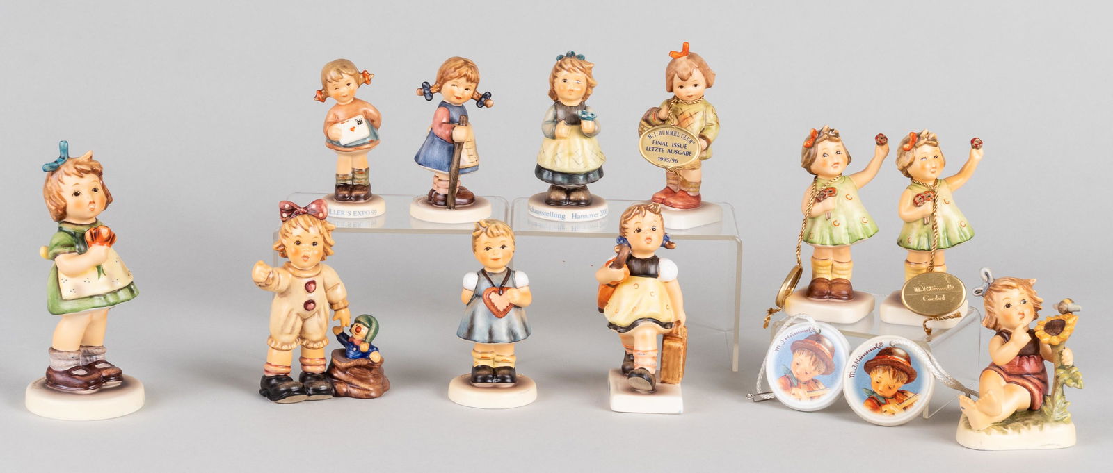 13 GOEBEL HUMMEL FIGURINES: 13 GOEBEL HUMMEL FIGURINES Lot of thirteen porcelain German Hummel figurines, including 'Merry Wandress #2197', 'Looking Around #1672', two 'Forever Yours #793', 'My Hearts Desire', 'Sunflower Friends