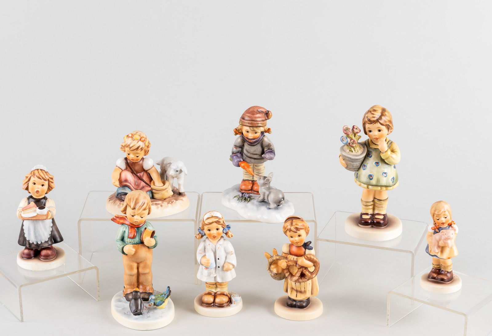 8 GOEBEL HUMMEL FIGURINES: Lot of eight Goebel Hummel figurines, including 'Maid To Order #1633', 'Pretzel Girl #1355', 'Spring Sowing #1498', 'Comfort And Care #1568', 'Peaceful Offering #1391', 'Pigtails #1382', 'My Wish is S