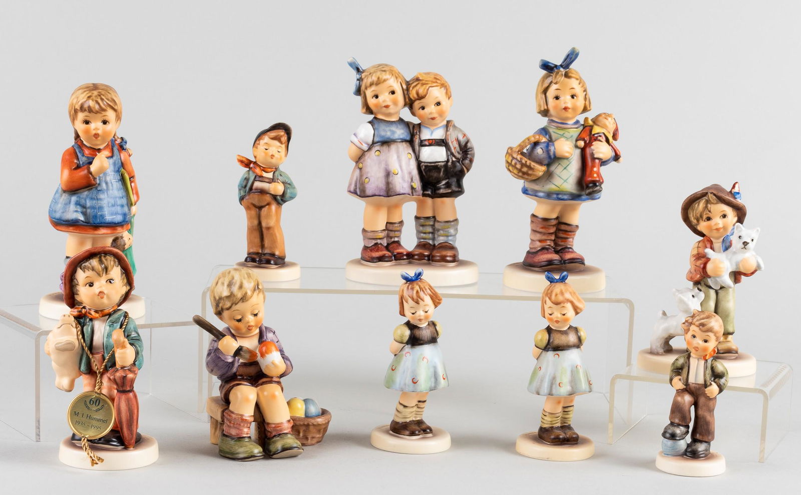 10 GOEBEL HUMMEL BOYS & GIRLS FIGURINES: Group of ten Goebel Hummel figurines, including 'The Little Pair #239', 'I Wonder #241', 'A Sweet Offering #144', two 'Two Hands One Treat #192', 'What's New #422', 'Easter's Coming #1573', 'Lucky Boy