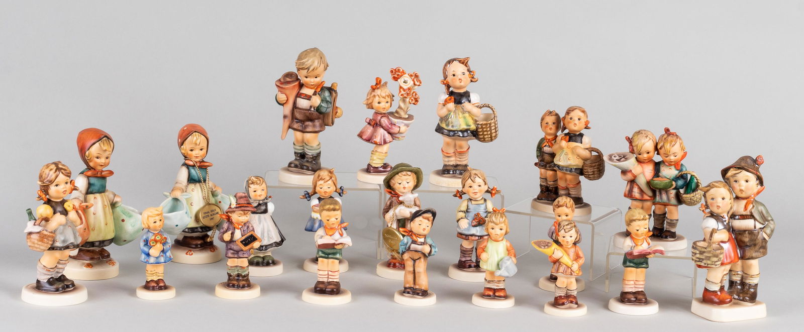 21 GOEBEL HUMMEL FIGURINES: Large collection of twenty-one German porcelain Hummel with boxes. Minor chipping to one figurine.
