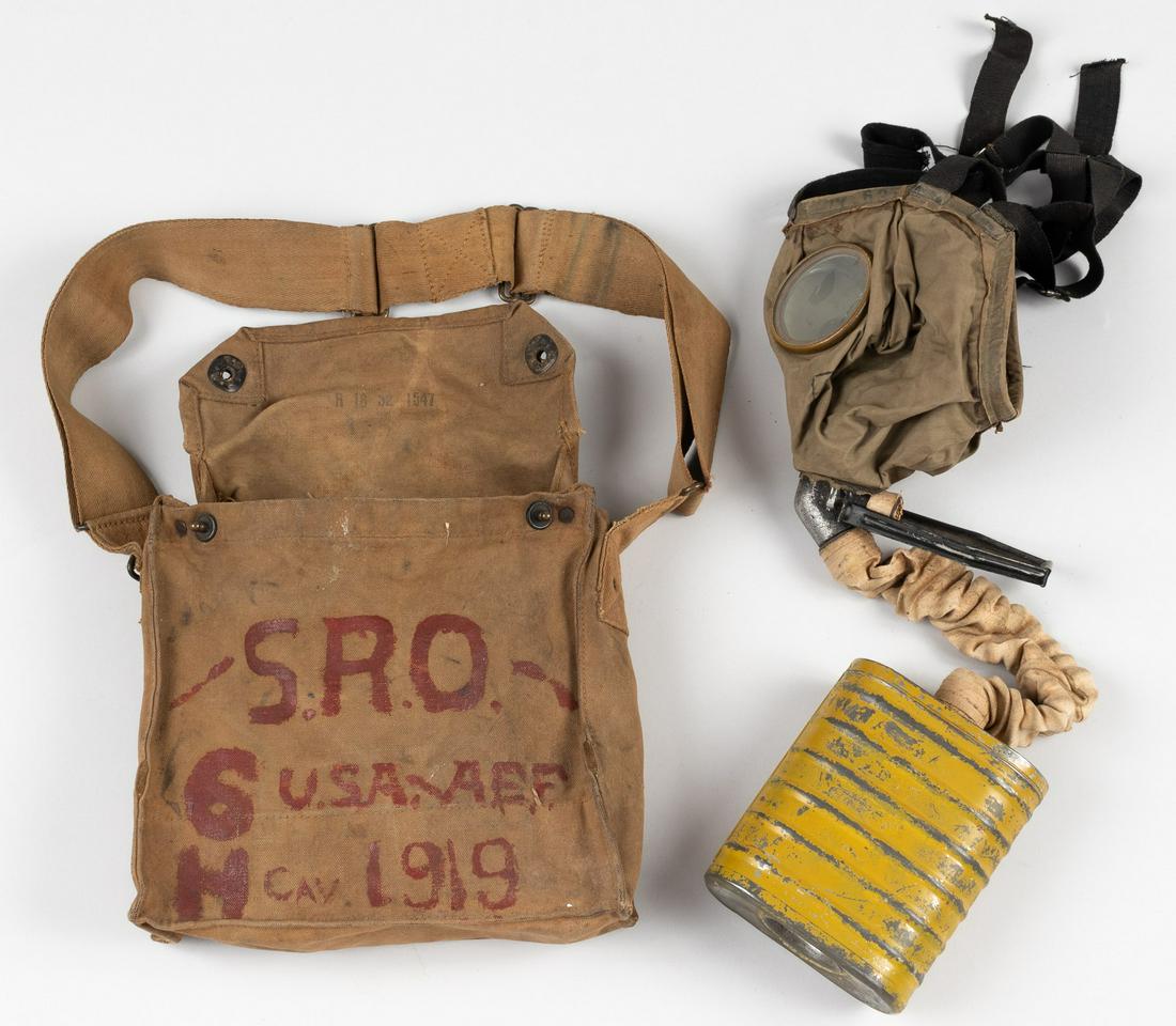 WWI AMERICAN GAS MASK: WWI gas mask with pouch, filter, and hose. Canvas pouch is painted on the side, 'S.R.O. - 6H - U.S.A./A.E.F. CAV. 1919'. Top lid of pouch is marked, 'R 16 32 1547'. Gas mask is marked on nose, '130T 1