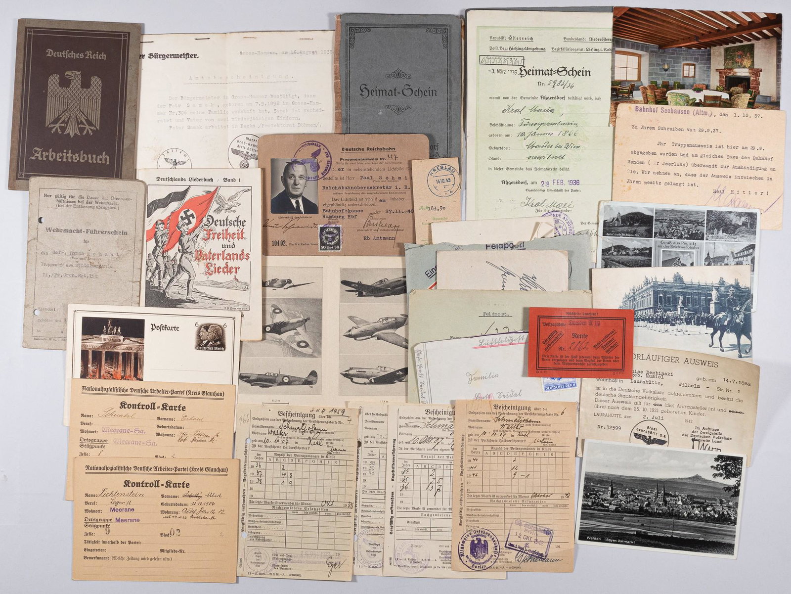 WWII GERMAN DOCUMENTS GROUP: Lot of 22 WWII German documents including Arbeitsbook, envelopes, postcards, 'Kontroll-Karte', a German songbook, identification chart of British fighter planes, Wehrmacht driver's license, NSDAP memb