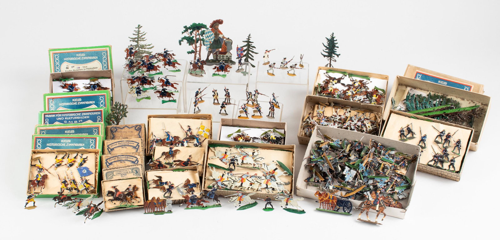 LARGE GROUP OF GERMAN FLAT TIN SOLDIERS: Large lot of over 600 early German flat tin (pewter) soldiers and accessories. Includes a figure of St. Florian, infantry and artillery soldiers, horses, canons, trees, etc. From makers 'Kieler Histor