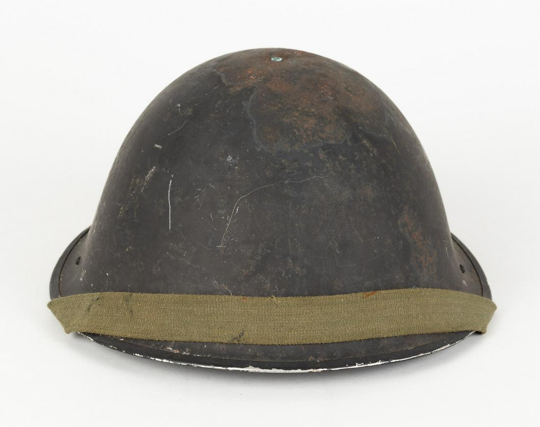1953 BRITISH TURTLE HELMET: British military turtle helmet with chinstrap, stamped inside crown 'CCL III 1953', marked on back inside rim, 'MA PL 4 1953'. Leather inner liner is fragile. Scuffing on rim and outer shell.