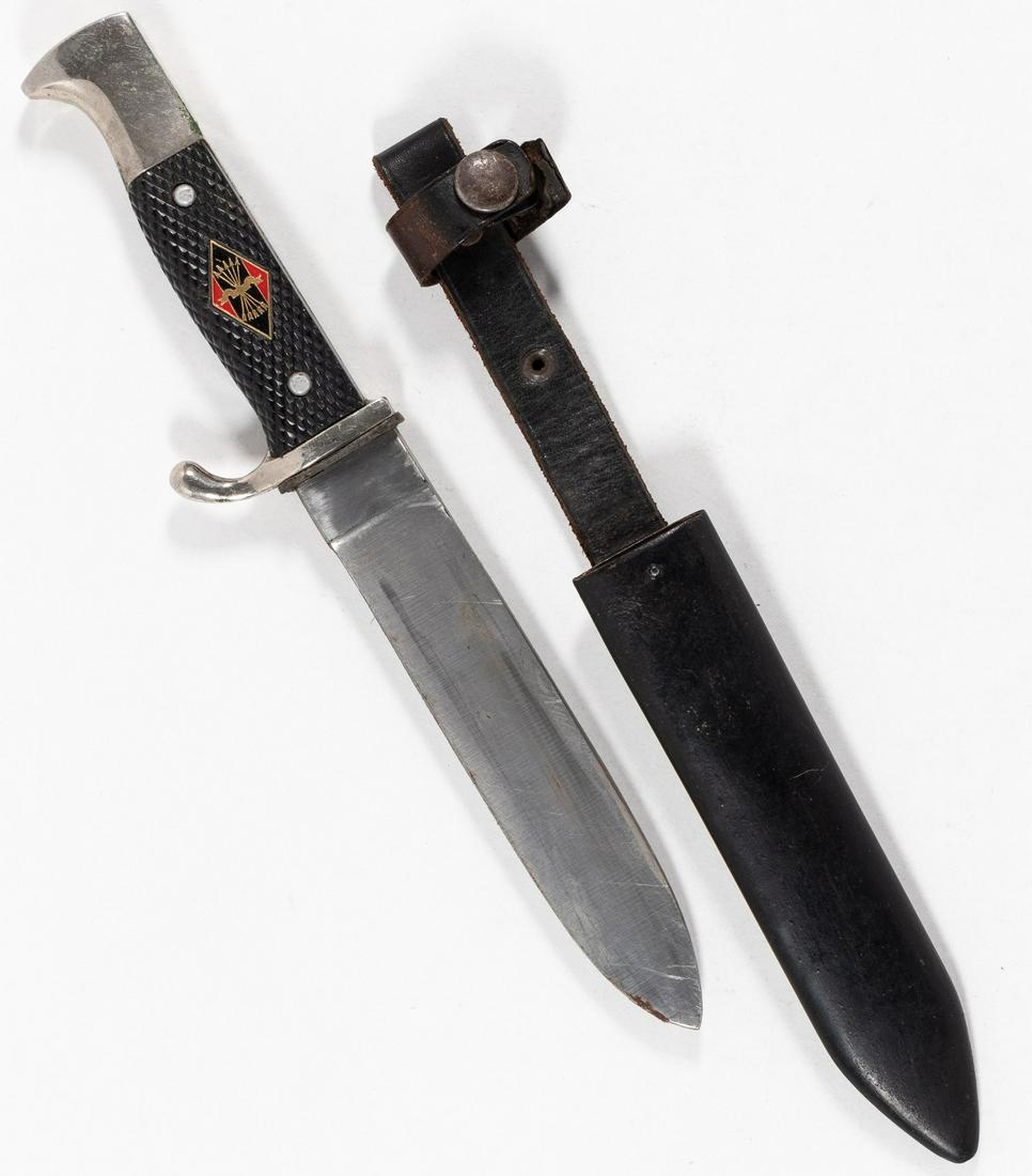 SPANISH HITLER YOUTH HJ DAGGER: Dagger featuring the symbol of the Frente de Juventudes, or Falange Youth, on the grip, silver trim, with leather padding at base of blade. Leather sheath is marked on verso 'LS' with an oak leaf and 
