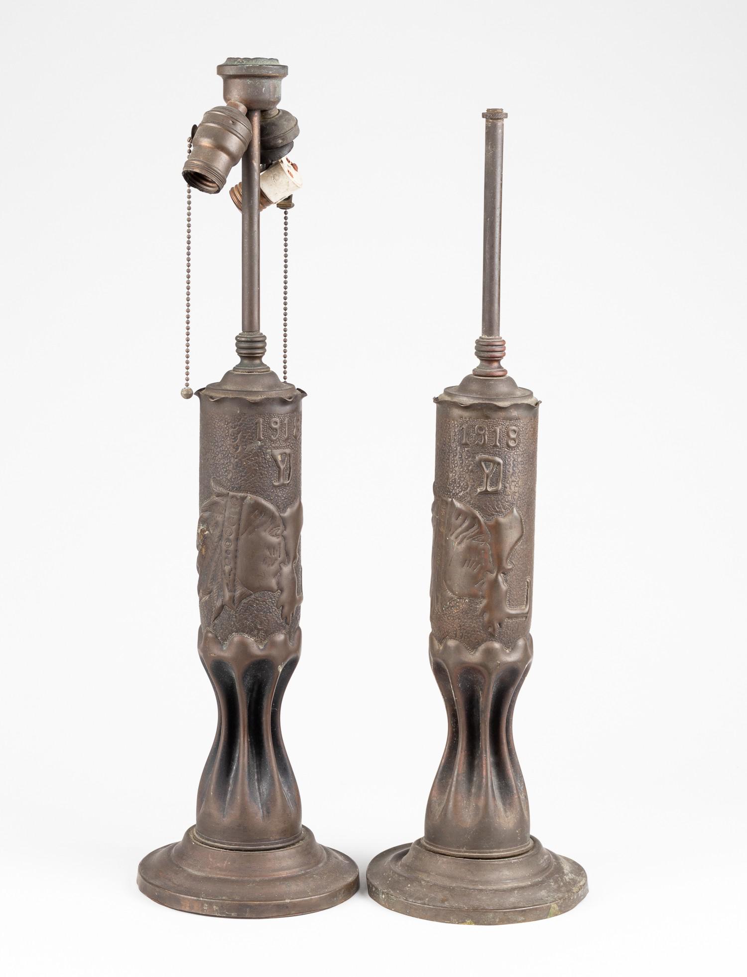 WWI TRENCH ART LAMP STANDS: Pair of two WWI trench art lamps, made from shell casings, embossed on side '1918 YD' with a Native American head, for the 26th Yankee Infantry Division, approx. 24 inches in height, 6.5 inches in dia