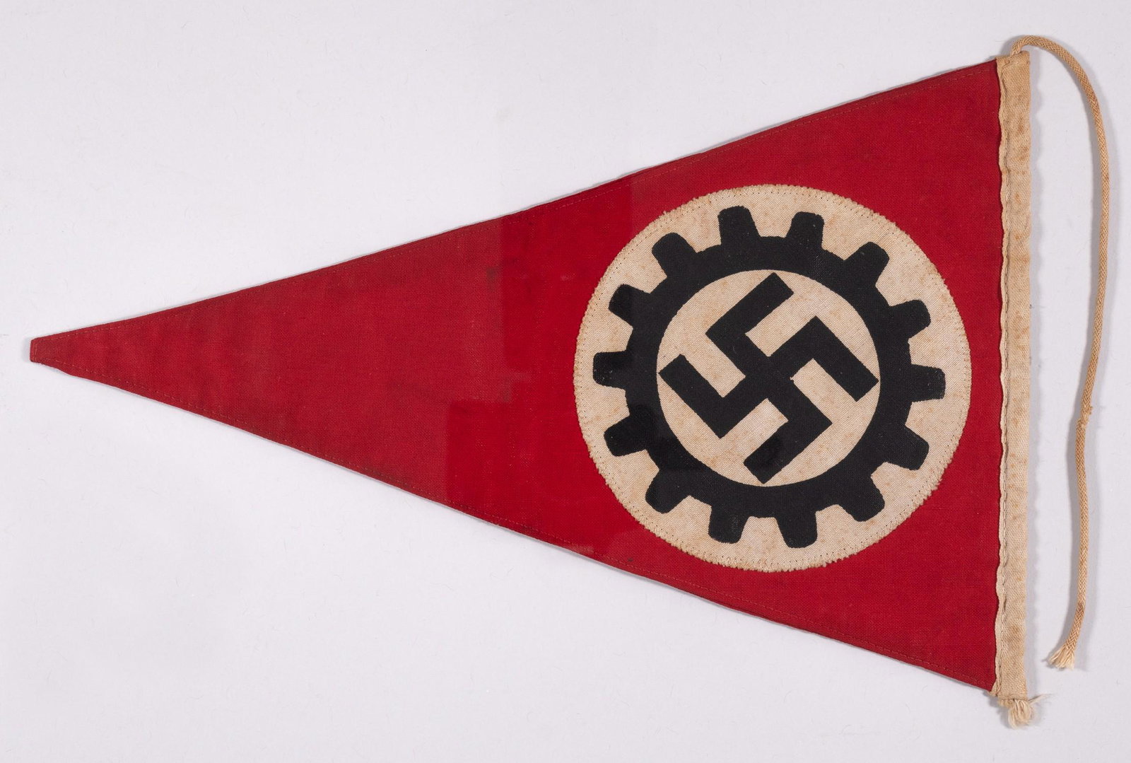 WWII GERMAN NAZI DAF GERMAN LABOR FRONT PENNANT: WWII German DAF Deutsche Arbeitsfront / German Labor Front pennant, double-sided red cloth flag with the DAF black cogwheel insignia printed onto a white disc sewn to either side of the flag. The hois