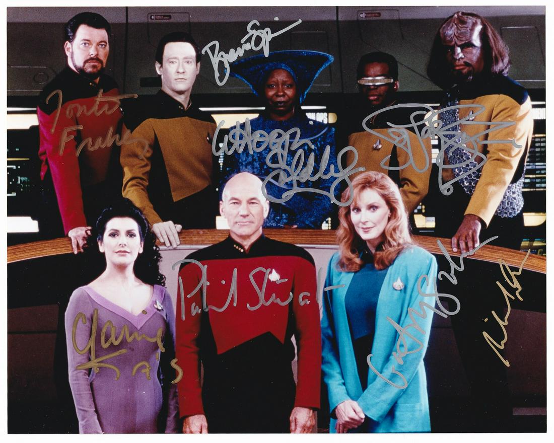 STAR TREK: THE NEXT GENERATION STARS SIGNED PHOTO: Color photo signed in gold and silver ink by Patrick Stewart (b. 1940), Whoopi Goldberg (b. 1955), LeVar Burton (b. 1957), Jonathan Frakes (b. 1952), Brent Spiner (b. 1949), Michael Dorn (b. 1952), Ma