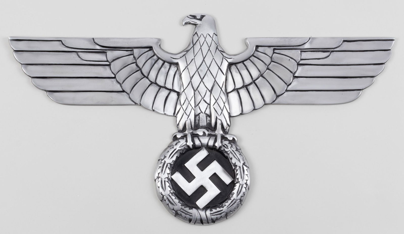 POST-WAR GERMAN RAILWAY EAGLE: Post-war casting of a Nazi Railroad eagle. 27.5 wingspan by 15 inches tall. Blackened cast aluminum front, with four threaded mounting holes on the back.