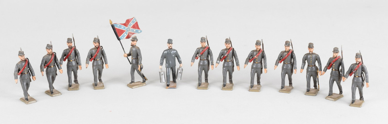 C.B.G. MIGNOT AMERICAN CIVIL WAR CONFEDERATE TOY SOLDIERS: Set of 13 Mignot hand painted American Civil War Confederate soldiers in box. Includes eleven infantry men, one captain, one water carrier and one flag bearer with a confederate flag. Made in France.