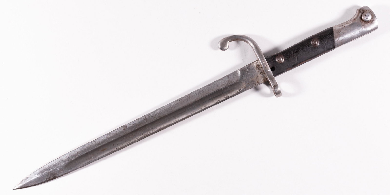 GERMAN MADE BRAZILIAN M1934 BAYONET BY SIMSON: German-made Brazilian M1934 bayonet by Simson & Co. Suhl. Grip made of dark wood, cross guard, and muzzle ring. Bayonet is marked 2062 on cross guard. Pitting on blade, hole in top of grip. Blade 11.7