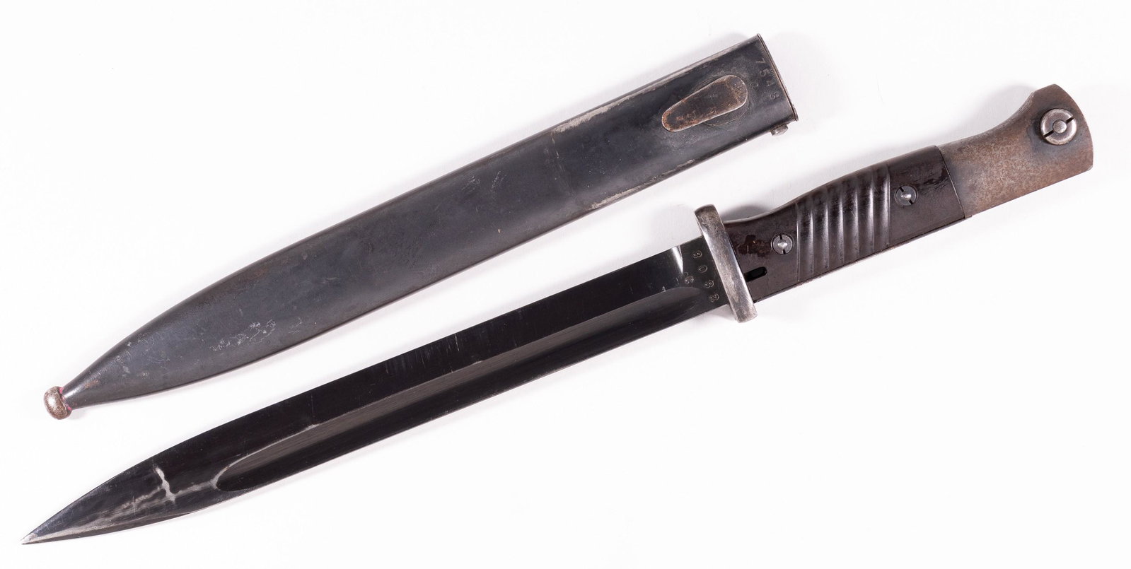 GERMAN M1884/98 BAYONET: German WWII bayonet M1884/98 third pattern. Dark brown celluloid grips and blued blade. Blade marked 'J.Sch.', on verso marked '8082C', pommel marked '655' and '656'. Scratches on blade, loss of finis