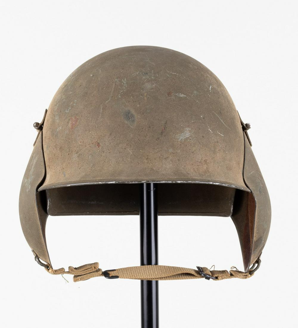 AMERICAN WWII M3 FLAK HELMET: American WWII M3 Flak Helmet. Worn by USAAF air crew for protection against flak. Hinged armor ear cuffs, one ear pad missing. Marked 149 on skirt. Liner and chinstrap.