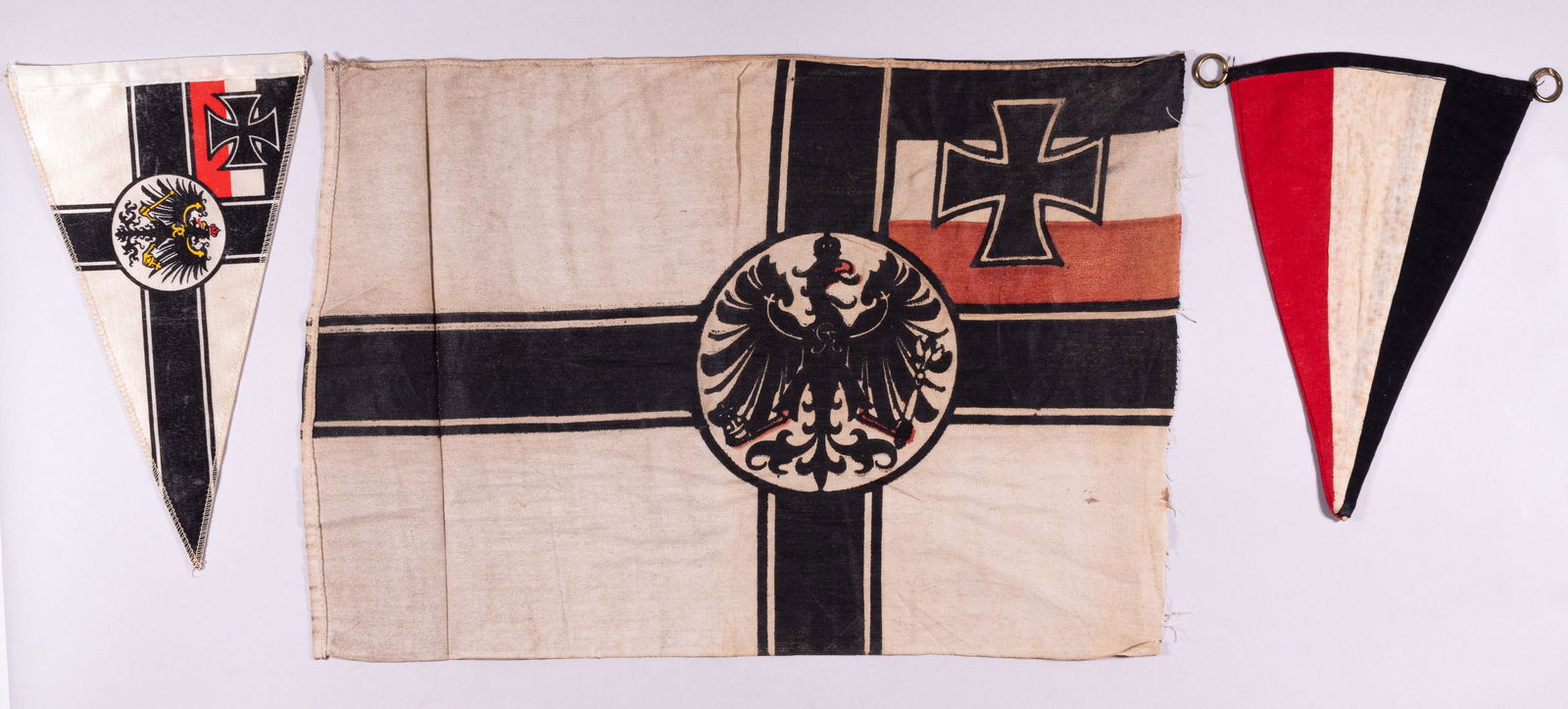 3 IMPERIAL GERMAN FLAGS: Three Imperial German flags. The first is an Imperial German War Flag, double-sided, used from 1903-1919. The flag features tri-colors of black white and red horizonal line with a Iron cross in the fo