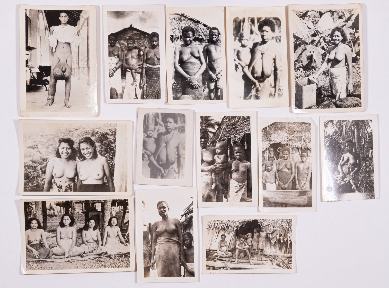 13 WWII NEW GUINEA PHOTOGRAPHS: A group of 13 New Guinea photographs. The photographs feature the native population posing for photographs partially nude. Average photograph 2.75 x 4.5 inches.