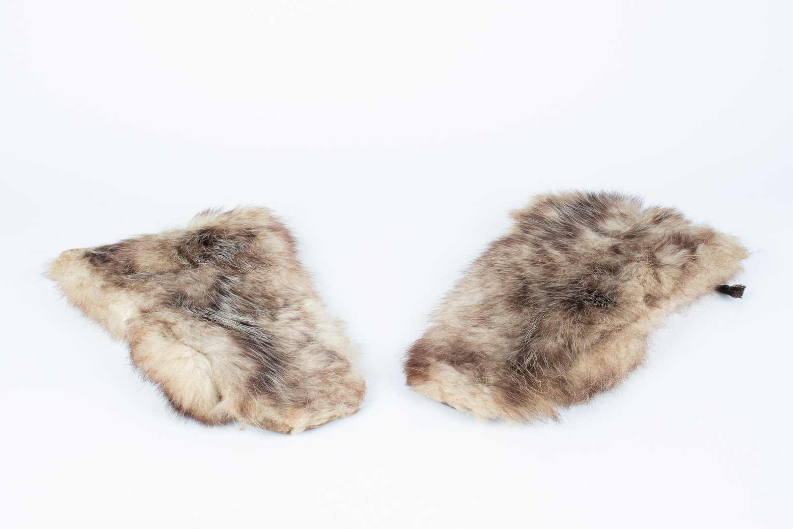 WWII US WINTER FUR FLYING MITTENS: Pair of WWII U.S. fur winter flying gloves. The gloves are made of light-colored fur, lined with a green wool material and padded leather palms. Small tear in the forearm of the right glove.