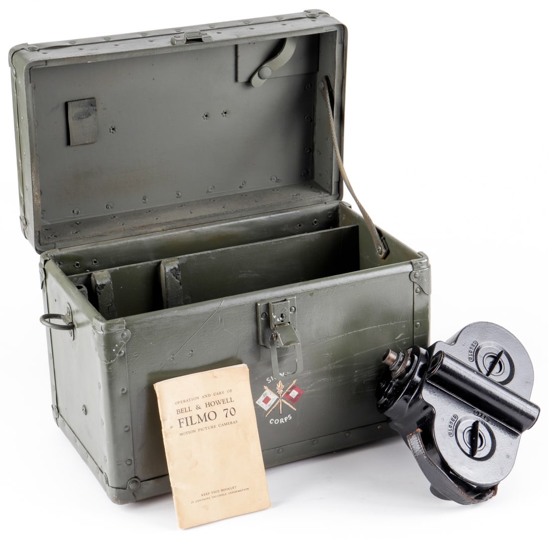WWII SIGNAL CORPS BELL & HOWELL FILMO 70 CAMERA: An American WWII 'Filmo 70' camera manufactured by Bell & Howell housed in the original Signal Corps marked carrying case with the key for the camera, and an operator's manual. Camera approx 6.75 x 8.