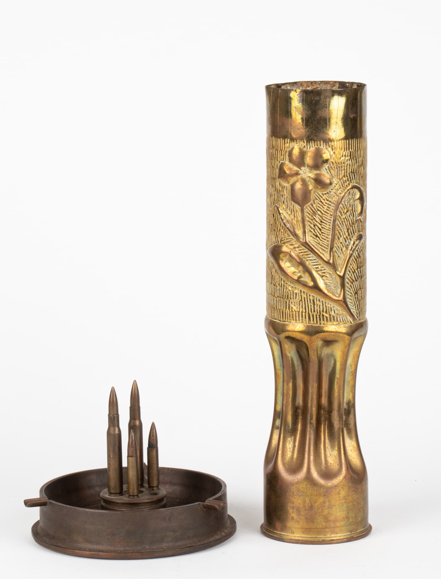 WWI TRENCH ART VASE AND ASHTRAY: WWI trench art vase with a flower and shield design made out of a brass shell. Marked 'Remington U.M.C., 75 DEC, 157L4 16 C' on the bottom of the vase. 13.5 x 9 inches. WITH: Trench art ashtray made o